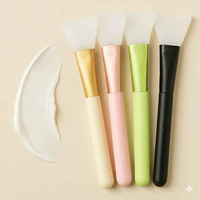 FrostVibe™ silicone brush close-up — flexible bristles for even serum distribution across face — red light therapy gua sha FrostVibe